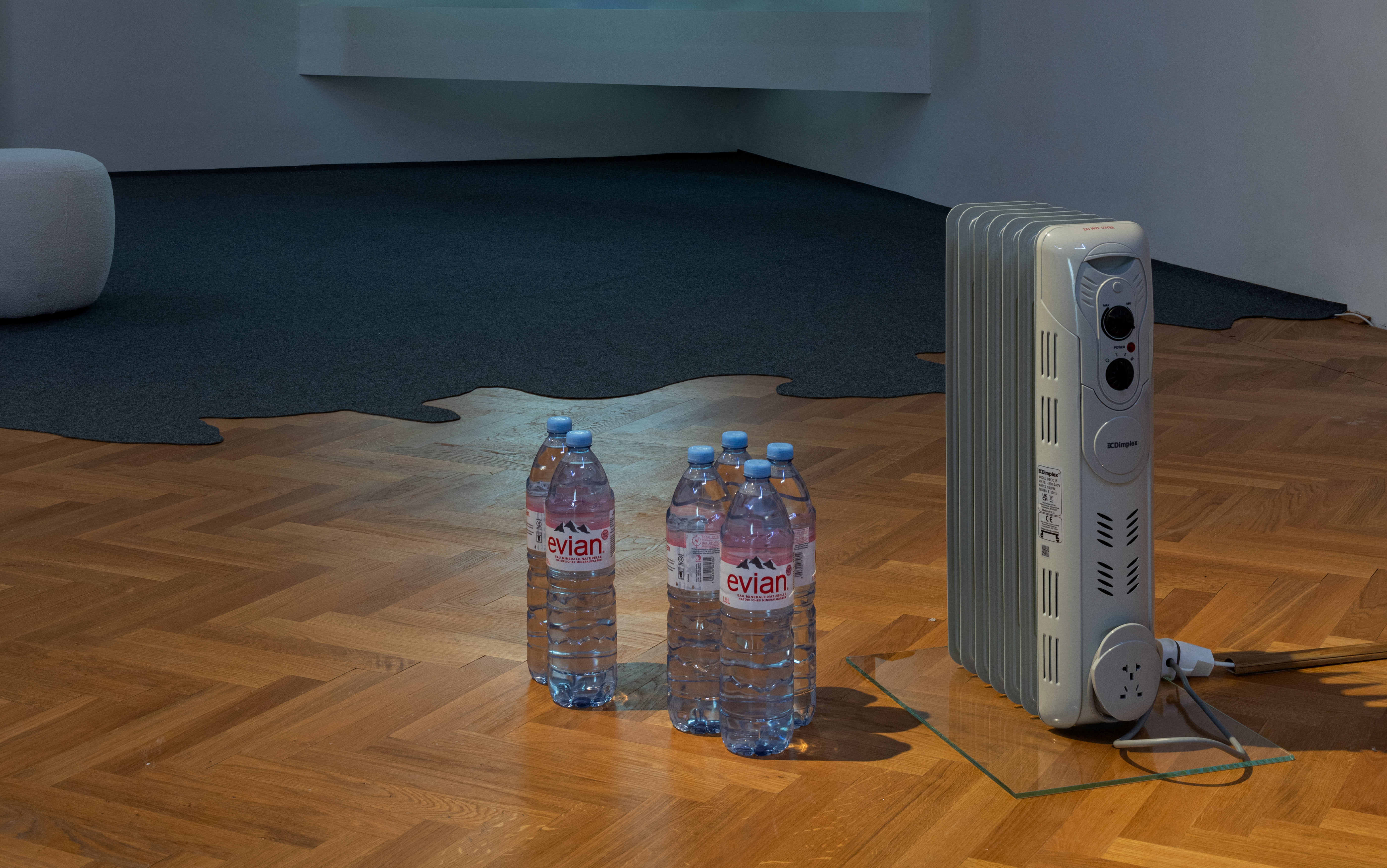 interior of a gallery with a radiator with bottles of water at the front right