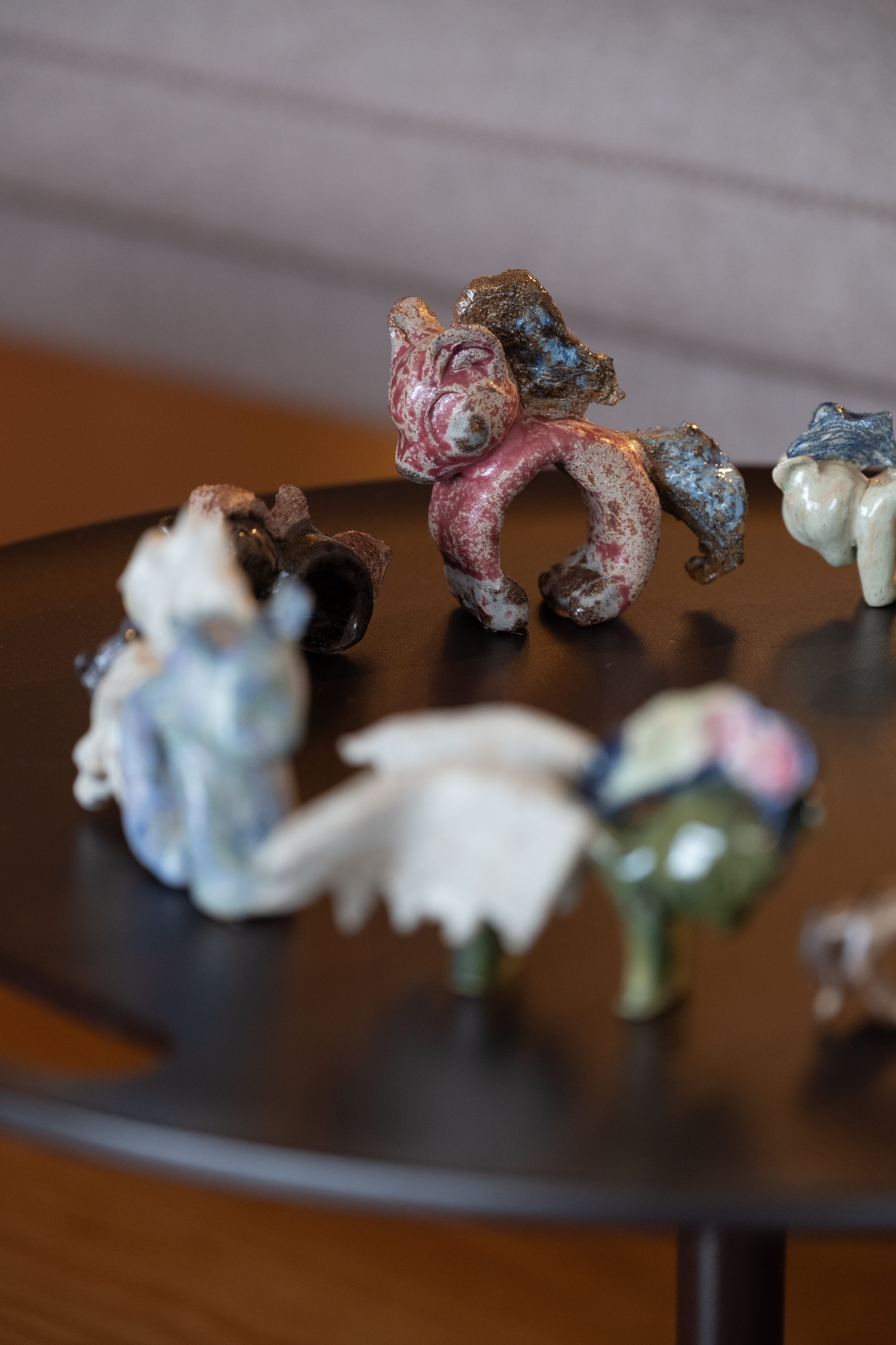 a small table on which sits a circle of toy horses
