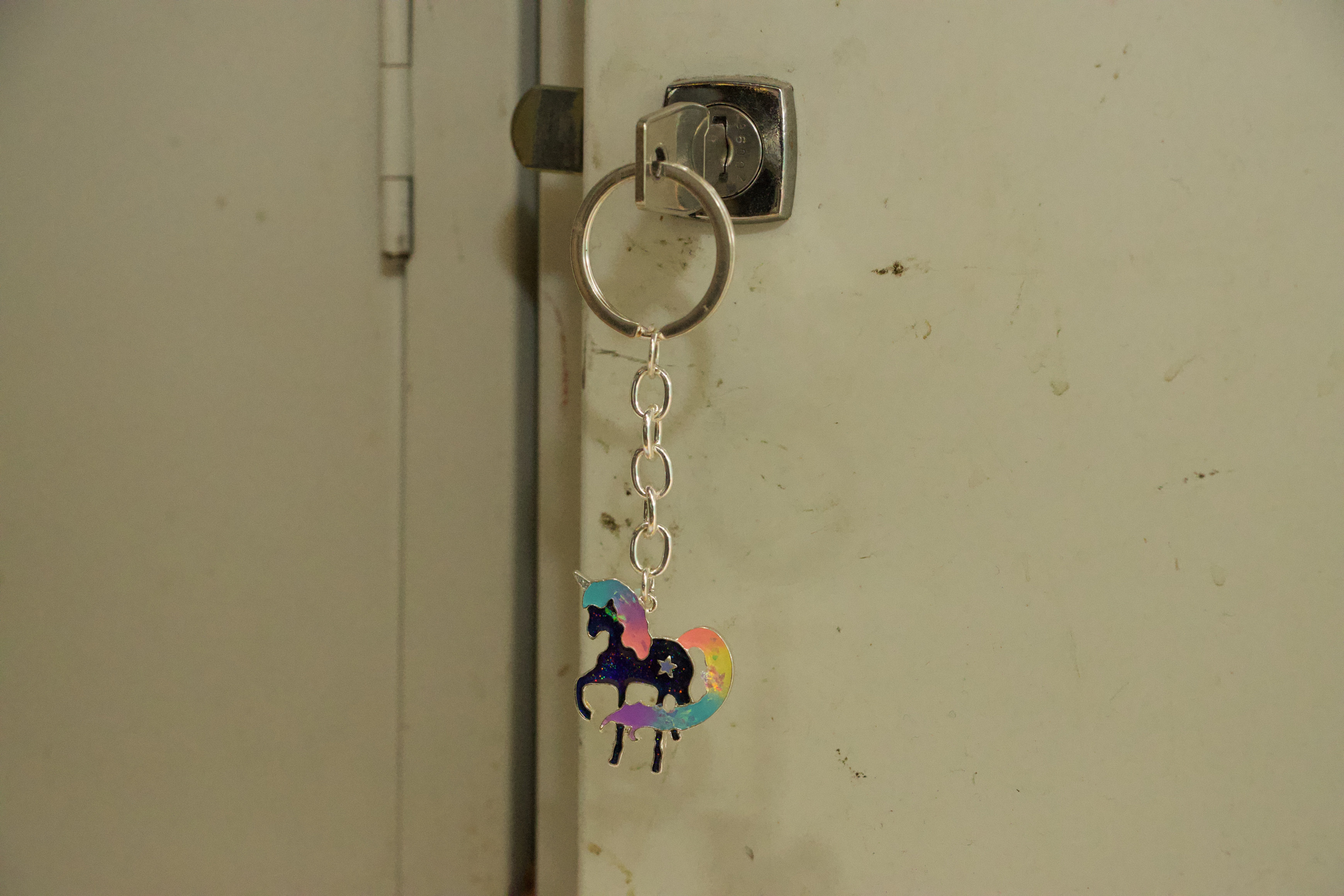 a unicorn keyring hanging from a locker