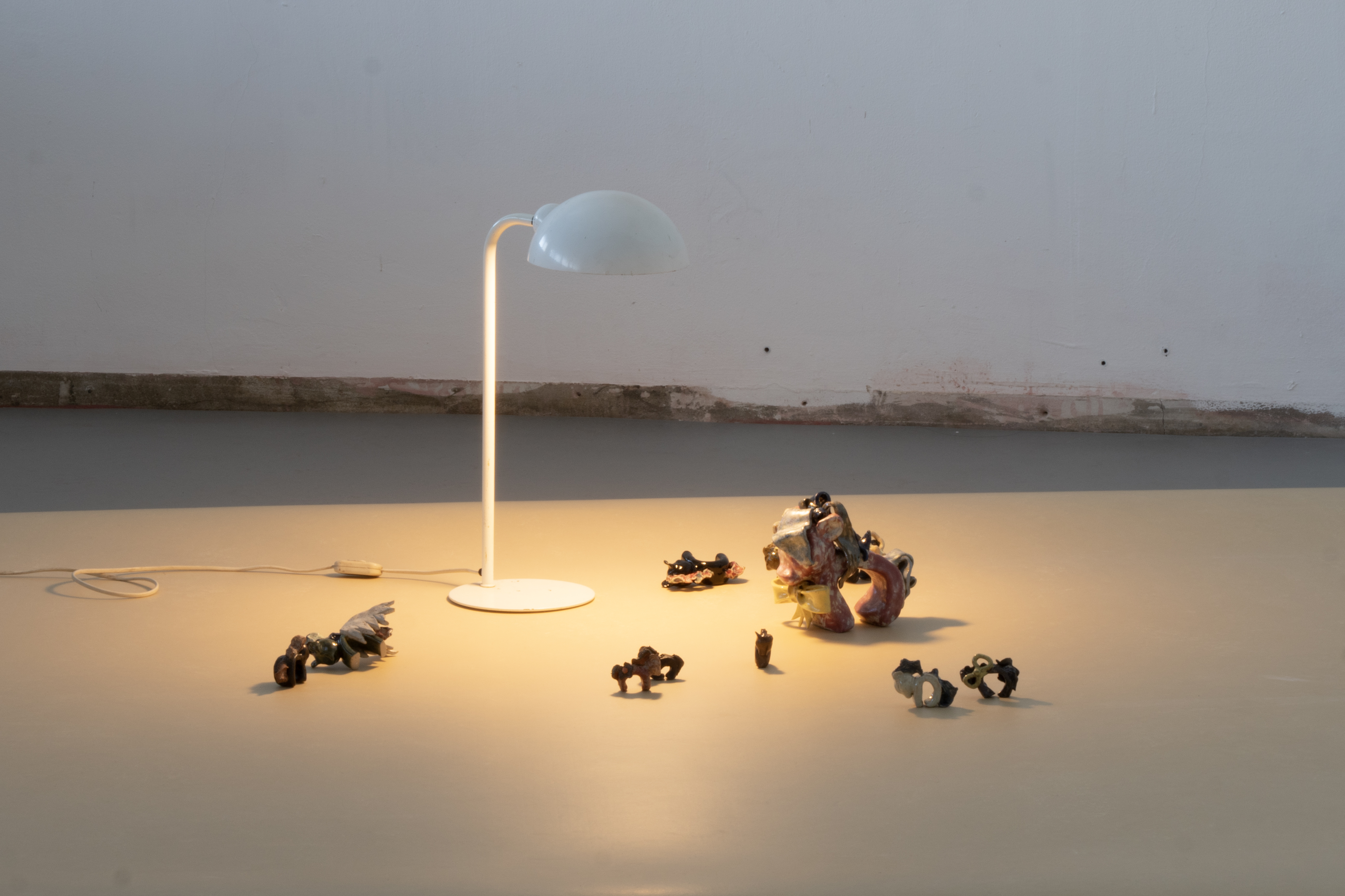 a white lamp, ceramic horses and marmoleum