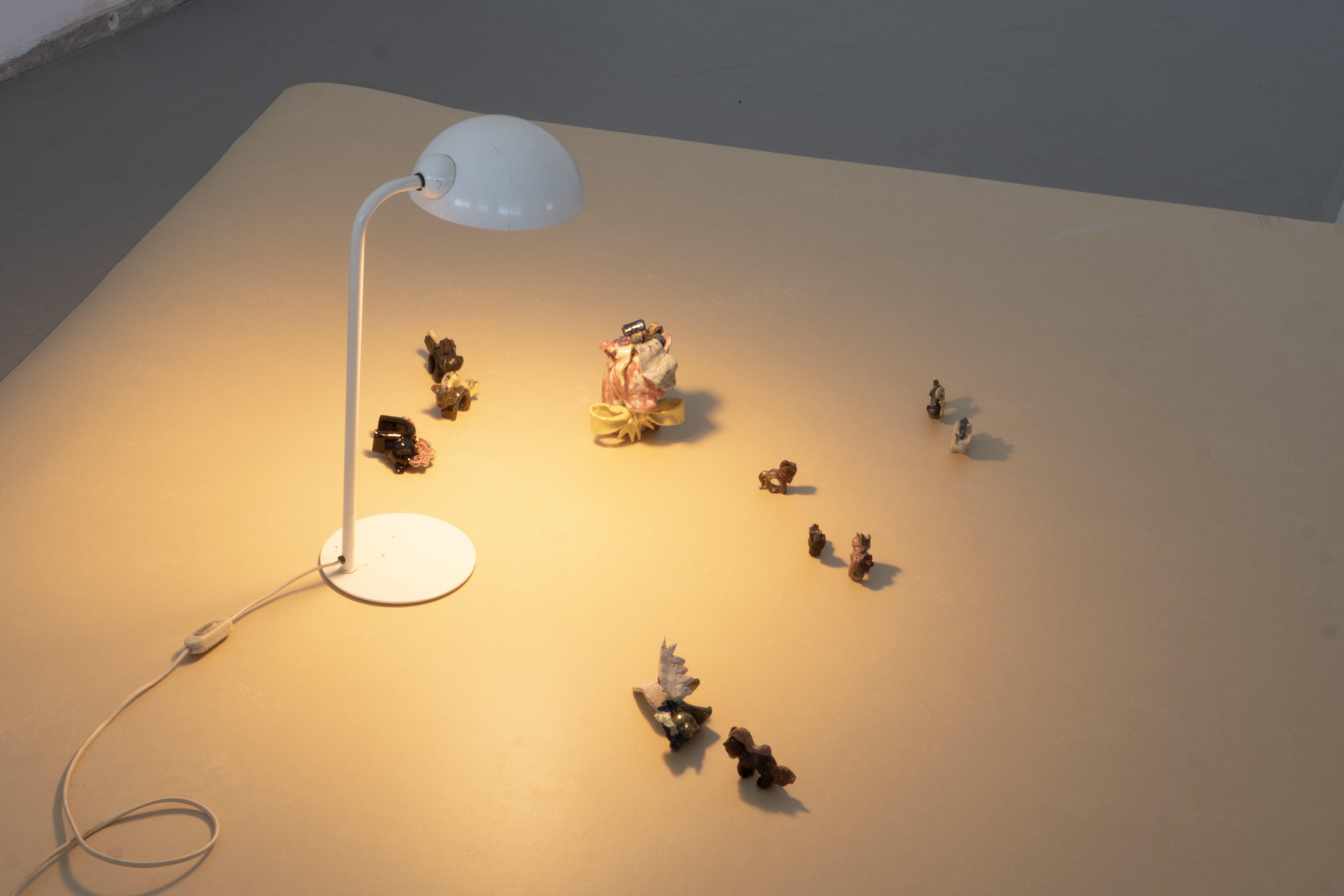 a white lamp, ceramic horses and marmoleum